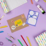 Circus Multi Sticker Kids & Colouring Birthday Card displayed on purple background with colorful stickers, craft supplies, and decorative elements including pencils, washi tape with polka dots, and blank coloring spaces ready for personalization