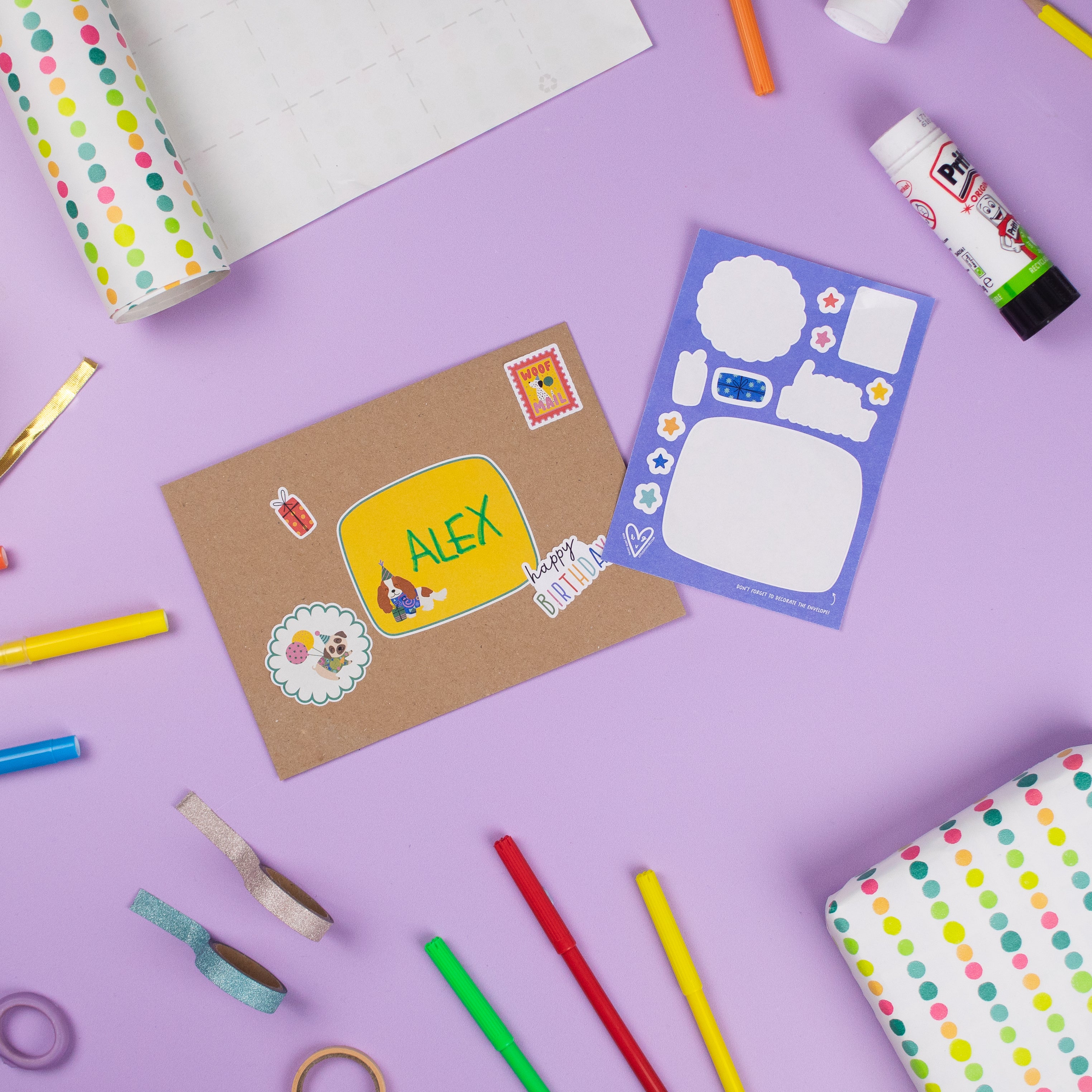 Football Multi Sticker & Colouring Kids Birthday Card displayed on purple background with colorful markers, polka dot washi tape, and craft supplies. Card features personalized name space and decorative sticker elements on kraft paper, alongside blue sticker sheet with blank spaces.