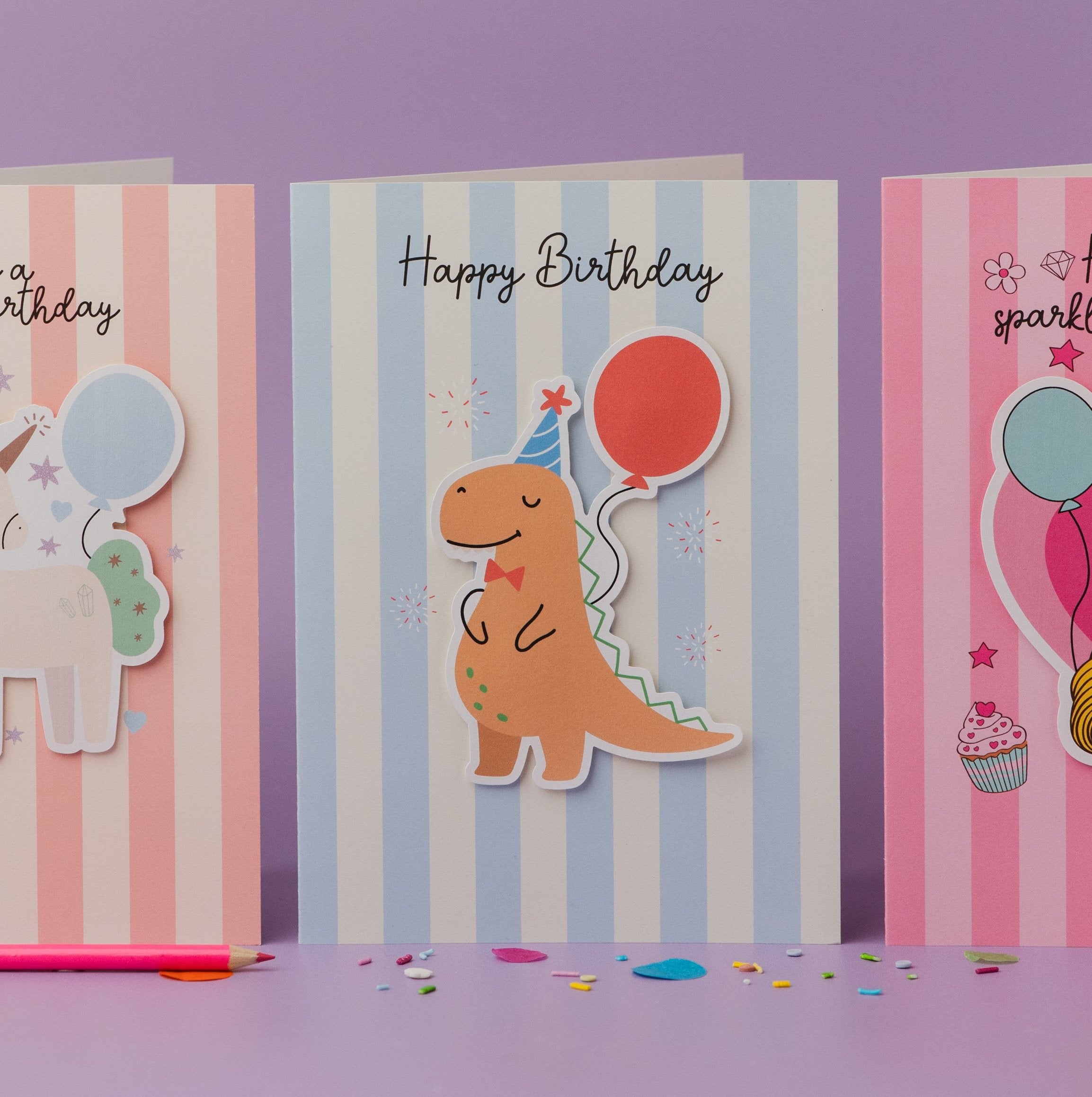 Have a Roaring Birthday Dinosaur Personalised Sticker & Colouring Kids Birthday Card featuring an orange cartoon dinosaur with party hat and red balloon on blue and white striped background, accompanied by Happy Birthday text and removable sticker design