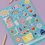Sheet of colorful stickers with various designs on a purple background