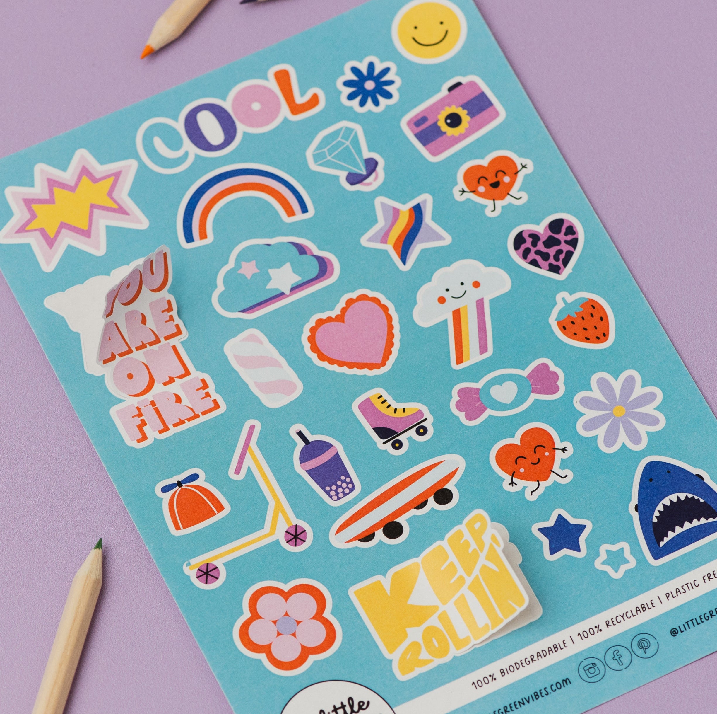 Sheet of colorful stickers with various designs on a purple background