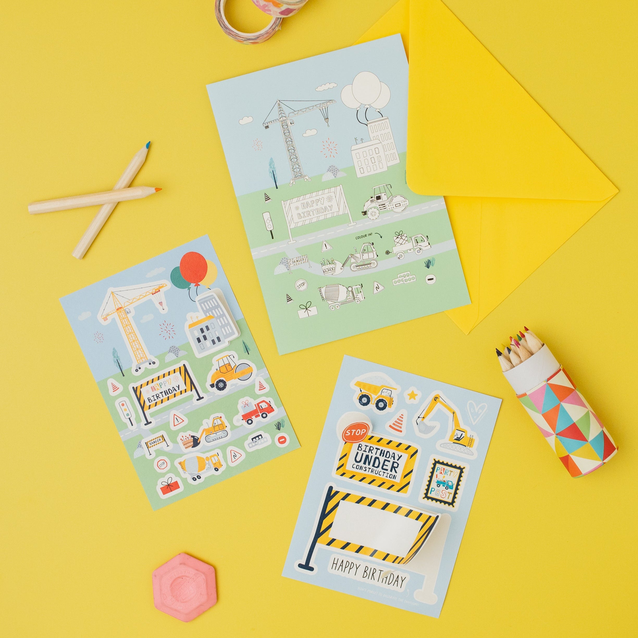  birthday cards with construction theme stickers on a yellow background
