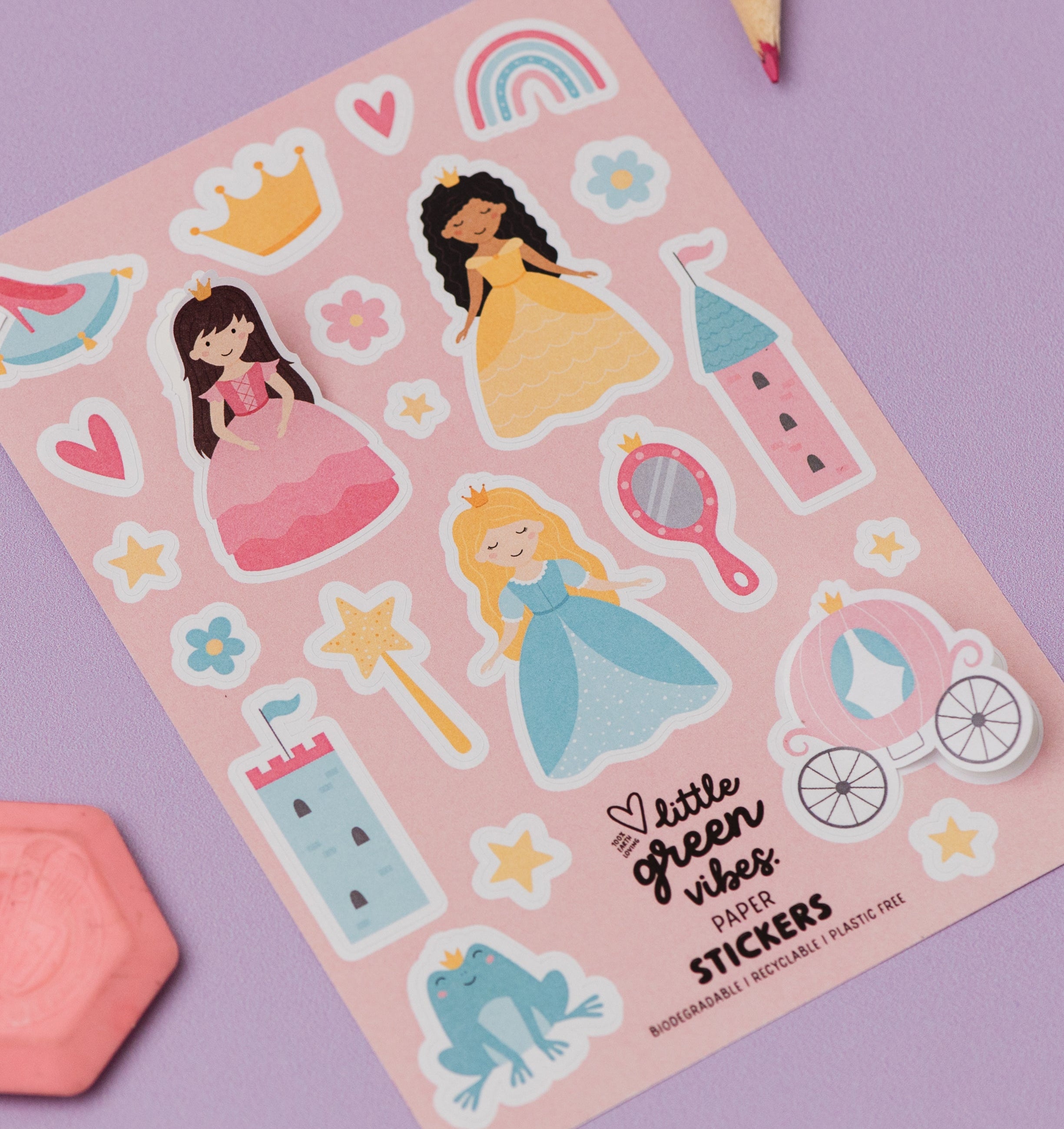 Sheet of stickers with princesses, castles, and other elements on a pink background