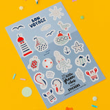Sheet of 'Bon Voyage' nautical themed stickers on a yellow background with colourful markers.