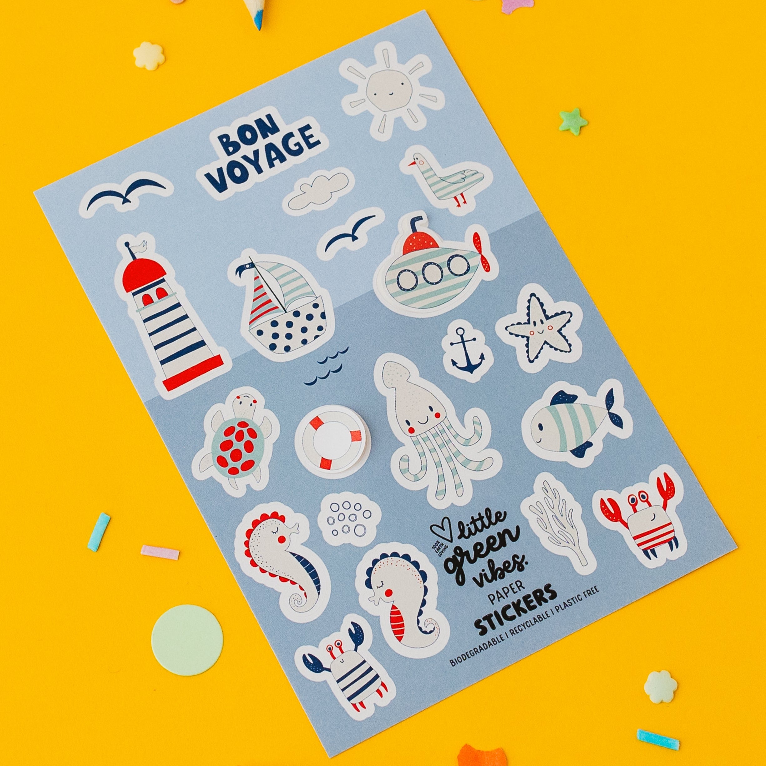 Sheet of 'Bon Voyage' nautical themed stickers on a yellow background with colourful markers.