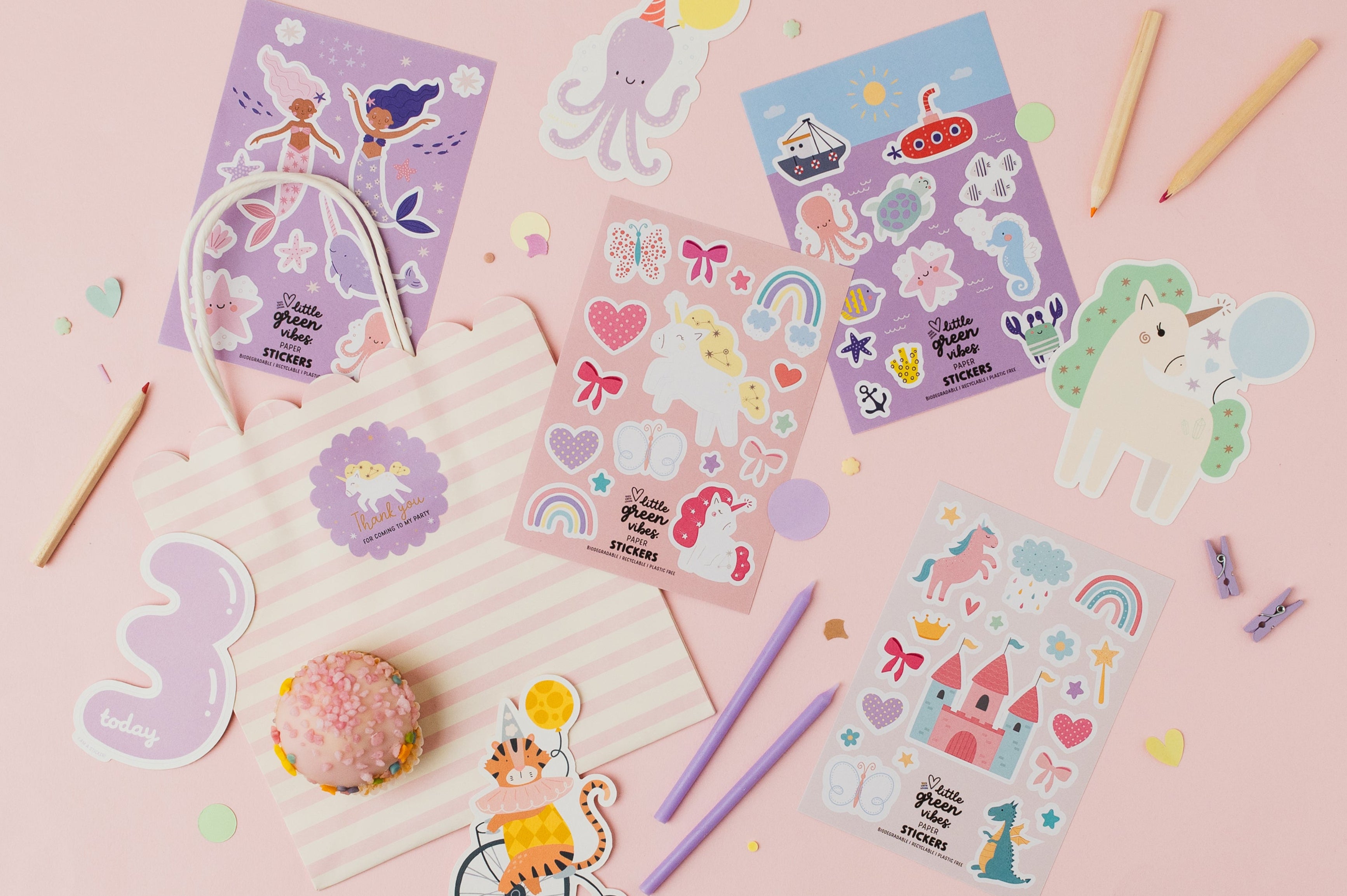 Set of colourful sticker sheets for children with under the sea, mermaid, unicorns and princess designs on a pink background. Includes a party bag, cupcake and candles.